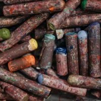 Close-up of a pile of used, colorful oil pastels showcasing art materials and creativity.